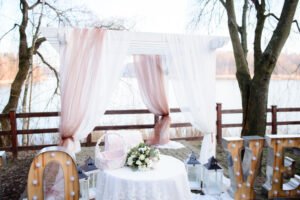 Beautiful wedding altar made of white and pink curtains on white frame